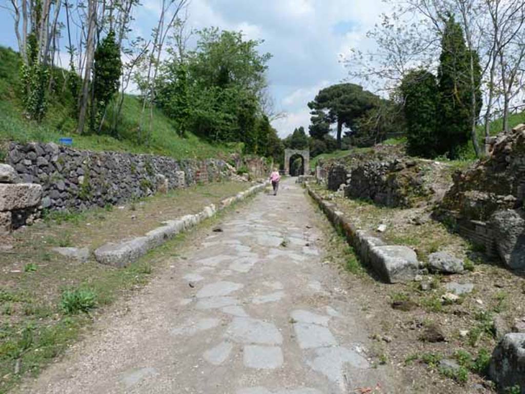 Via di Nola, May 2010.  Looking east between IV.5 and III.11, from crossroads with unexcavated unnamed vicoli.
