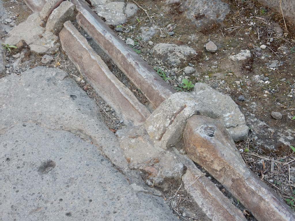 Vicolo dei Vettii, Pompeii, west side. June 2019. Detail of lead pipes in pavement outside VI.13.13.
Photo courtesy of Buzz Ferebee.
