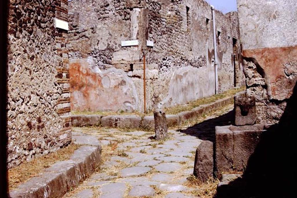 Vicolo di Tesmo, Pompeii. 1972. Looking north, with Vicolo di Balbo, on the left, and IX.7, on the right at rear of fountain..  Photo by Stanley A. Jashemski. 
Source: The Wilhelmina and Stanley A. Jashemski archive in the University of Maryland Library, Special Collections (See collection page) and made available under the Creative Commons Attribution-Non Commercial License v.4. See Licence and use details. J72f0112
