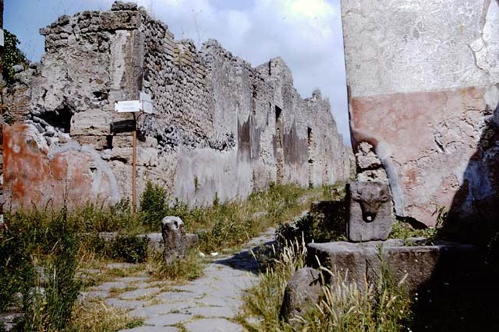 Vicolo di Tesmo, Pompeii. 1964. Looking north, with Vicolo di Balbo, on the left, and IX.7, on the right at rear of fountain. Photo by Stanley A. Jashemski. 
Source: The Wilhelmina and Stanley A. Jashemski archive in the University of Maryland Library, Special Collections (See collection page) and made available under the Creative Commons Attribution-Non Commercial License v.4. See Licence and use details.
J64f1602

