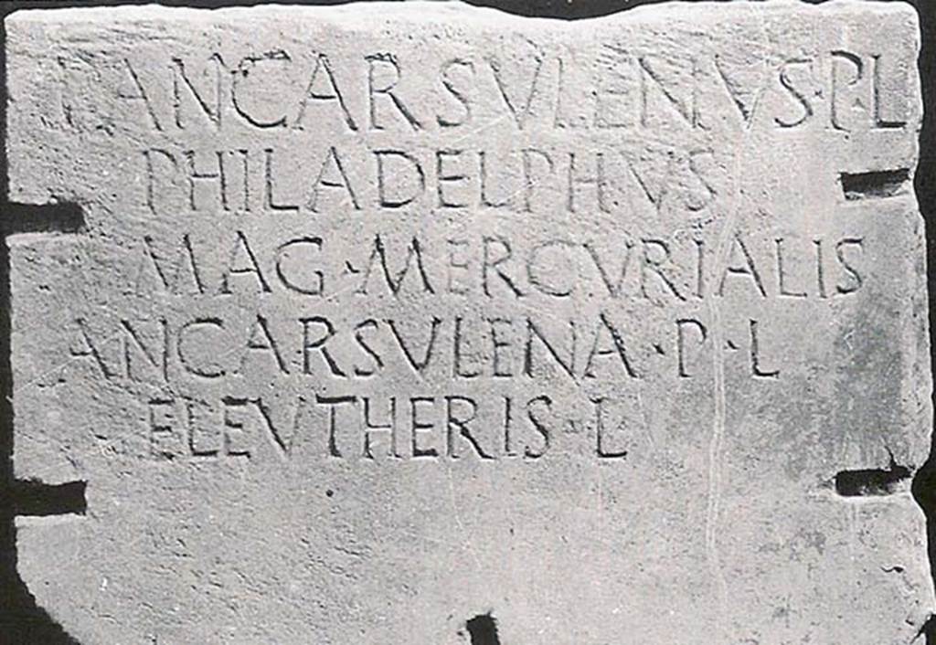 Tomba nei pressi cabina ENEL. Inscribed marble slab found 15th September 1970.
SAP Inventory number 14181. 

P ANCARSVLENVS P L
PHILADELPHVS
MAG MERCVRIALIS
ANCARSVLENA P L
ELEVTHERIS L

This expands to

P(ublius) Ancarsulenus P(ubli) L(ibertus)
Philadelphus
Mag(ister) Mercurialis
Ancarsulena P(ubli) L(iberta)
Eleutheris L(iberta)

Cooley translates this as:

Publius Ancarsulenus Philadelphus, freedman of Publius, president of Mercury, Ancarsulena Eleutheris, freedwoman of Publius, freedwoman.       [AE (1992) 285]

See Cooley, A. and M.G.L., 2004. Pompeii: A Sourcebook. London: Routledge. G33, p. 148.
See Cooley, A. and M.G.L., 2014. Pompeii and Herculaneum: A Sourcebook. London: Routledge, E40, p. 133.
Varone gives a more detailed analysis of the inscription, the names, and the possible meanings of magister Mercurialis.
See Varone A., 1998. Pompei oltre la vita: Nuove testimonianze dalle necropoli, p. 109.
