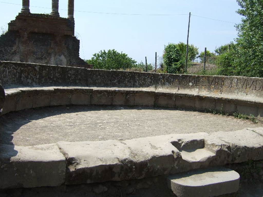 HGW04 Pompeii. May 2006. On the seat is the Latin inscription:
MAMIAE P F SACERDOTI PVBLICAE LOCVS SEPVLT DATVS DECVRIONVM DECRETO.

According to Epigraphik-Datenbank Clauss/Slaby (See www.manfredclauss.de) this reads

Mamiae(!) P(ubli) f(iliae) sacerdoti publicae locus sepultur(ae) datus decurionum decreto      [CIL X 998]

According to Cooley this translates as

To Mamia, daughter of Publius, public priestess, a place for burial was given by decree of the town councillors.

See Cooley, A. and M.G.L., 2004. Pompeii : A Sourcebook. London : Routledge. (p. 97, E40).