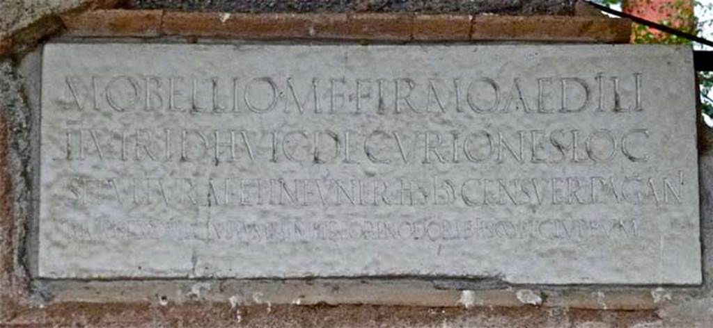 NGOF Pompeii. September 2011. Inscription on marble plaque from south wall of tomb of M. Obellius Firmus.
Photo courtesy of Michael Binns.
The inscription reads

M(arco) OBELLIO M(arci) F(ilio) FIRMO AEDILI
IIVIR(o) I(ure) D(icundo) HVIC DECURIONES LOC(um)
SEPVLTVRAE ET IN FVNER(ibus) HS IƆƆ CENSUER(unt) PAGANI
THURIS P(ondo) XXX ET CLUPEUM, MINISTR(i) EOR(um) IN ODORIB(us) HS CIƆ ET CLUPEUM

According to Cooley this translates as
To Marcus Obellius Firmus, son of Marcus, aedile, duumvir with judicial power. 
The town councillors decreed him a burial place and 5000 sesterces for his funeral;
the inhabitants of the country district decreed him 30 pounds of frankincense and a shield, and their attendants 1000 sesterces for perfumes, and a shield.
See Cooley, A. and M.G.L., 2004. Pompeii : A Sourcebook. London : Routledge. (p. 141, G12).
Franklin translates ministri as magistrates rather than attendants.
See Franklin J. L., 1999. Pompeis difficile est. University of Michigan. (p. 136).
