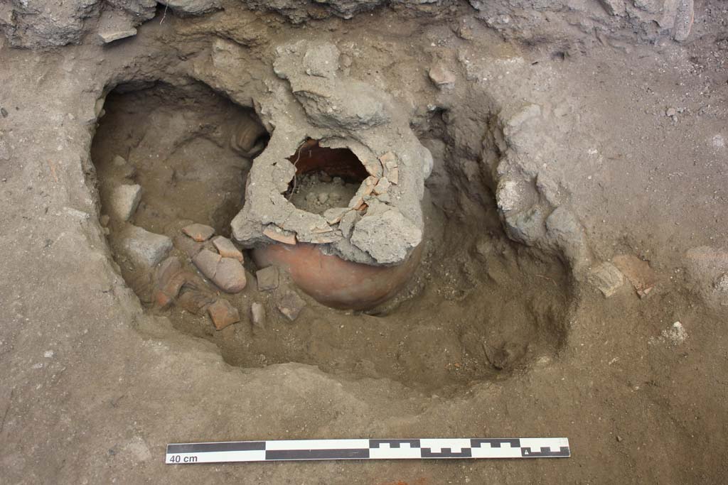 NGOF Pompeii. August 2015. Excavation inside the Tomb of Obellius Firmus, following the earlier excavations of the Soprintendenza (1976). 
The work revealed a second cremation urn, which contains the remains of a male individual in his 60s. 
Alongside the urn with the burial goods was a coin dating to between 66 – 69 AD.
Photo courtesy Stephen Kay, British School at Rome.
