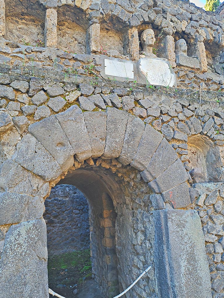 Pompeii Porta Nocera. October 2024. 
Tomb 7OS. Looking south towards central doorway, and busts and plaques with inscriptions. 
Photo courtesy of Giuseppe Ciaramella.
