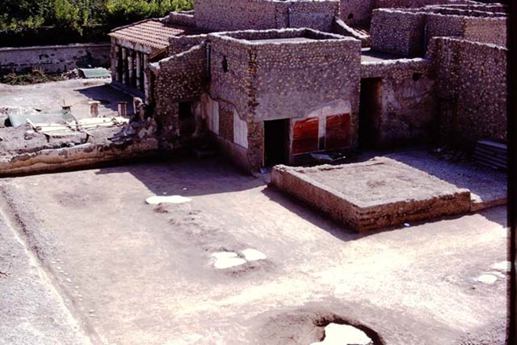 Oplontis, 1975. Area 56, looking south-west across north garden towards the painted plaster on exterior walls of room 55, towards the south-east peristyle (no.59).
Area 58, can be seen, on right.  Photo by Stanley A. Jashemski.   
Source: The Wilhelmina and Stanley A. Jashemski archive in the University of Maryland Library, Special Collections (See collection page) and made available under the Creative Commons Attribution-Non Commercial License v.4. See Licence and use details. J75f0533
