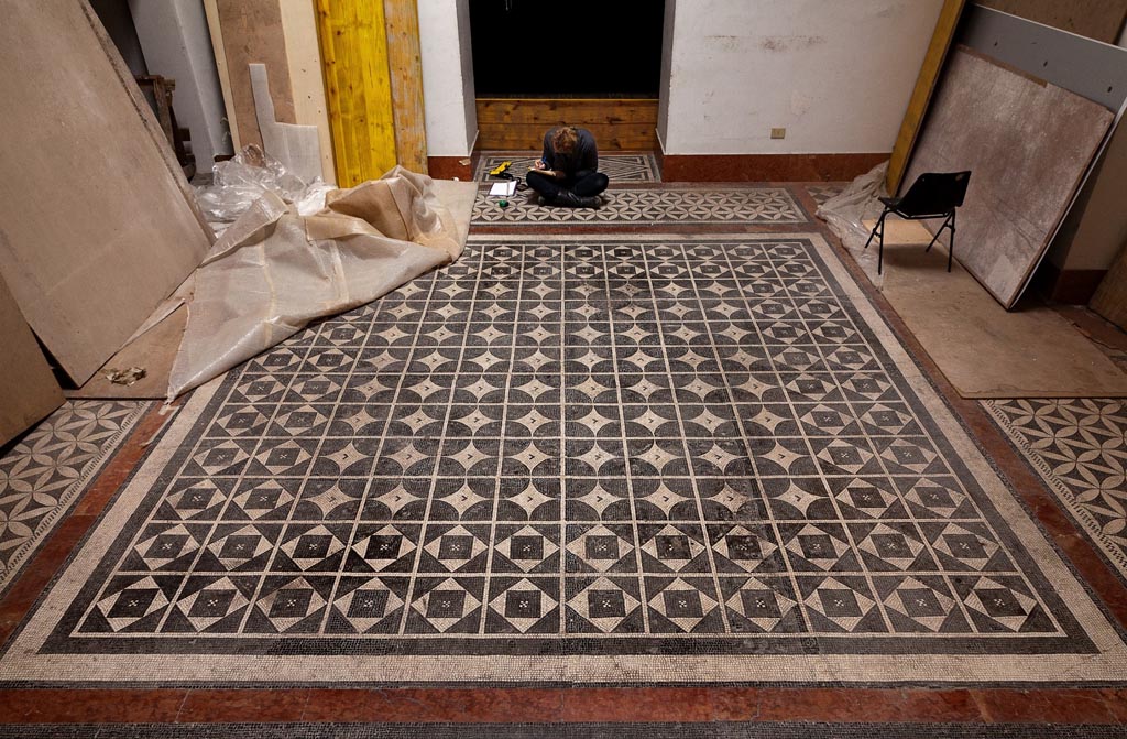 Naples Archaeological Museum, Room CXXIX. March 2013. Photo by Thomas Crognier for the ©Villa Diomedes Project, Image database.
Room CXXIX, however, has a mosaic carpet in the centre with rows of solid black circles, surrounded by a band of white rhombuses, inscribing squares alternating with black triangles.

Around the edge of the central mosaic are 3 (probably 4 but not all shown above) pieces of mosaic measuring 4.10m x 0.92.
This is possibly from the Second Complesso at Stabia. 
(Note: now Room CXXIX has been carpeted with a modern flooring, and these mosaic can no longer be seen there.)
(See Pisapia, no. 117 (p.580).
