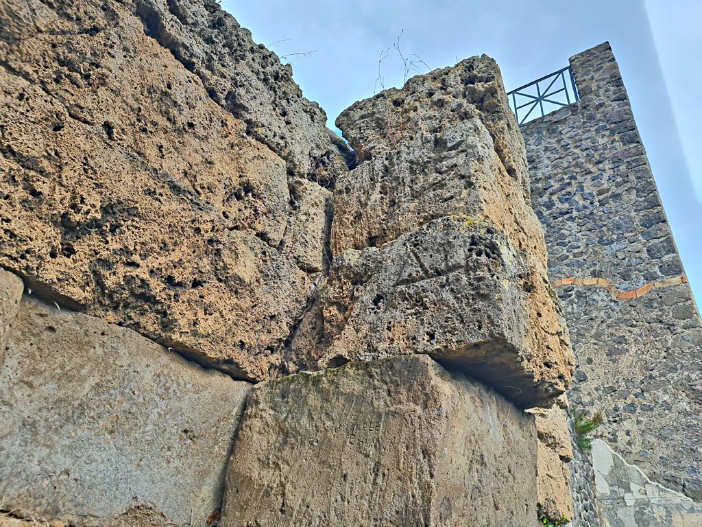 Walls on west side of Tower XI, Pompeii. November 2023. 
Detail of city wall and remaining masons’ marks. Photo courtesy of Giuseppe Ciaramella.
