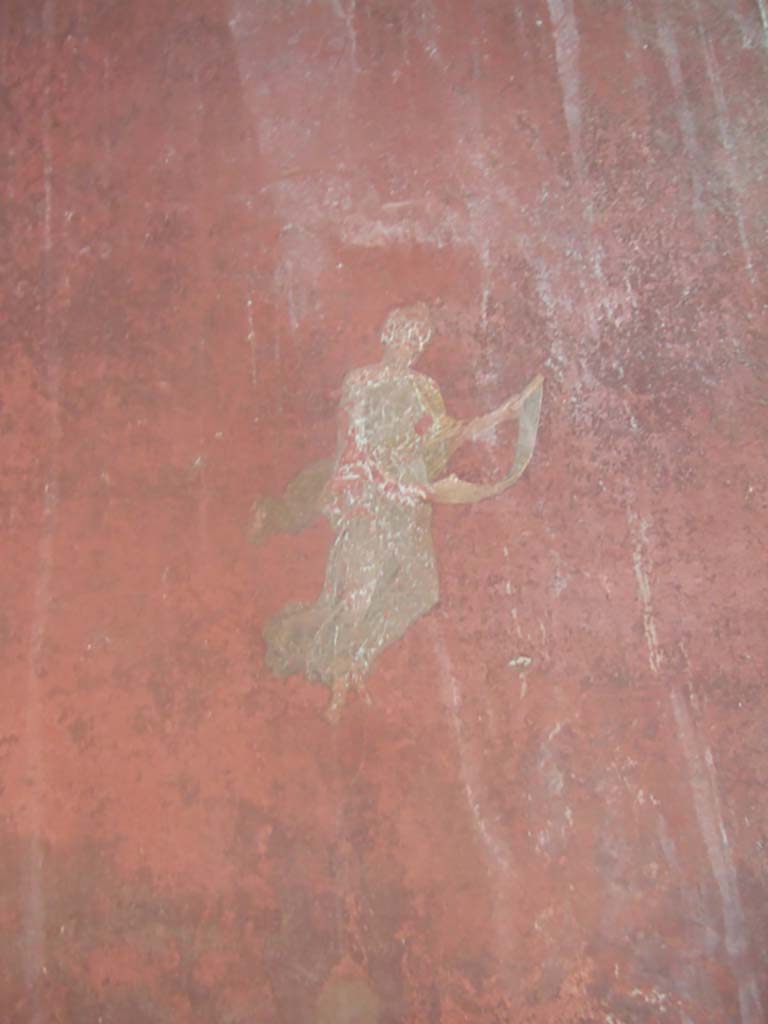 I.10.4 Pompeii. May 2006. 
Room 18, west wall on south side of doorway to peristyle, painting of floating Muse with roll of paper. 
