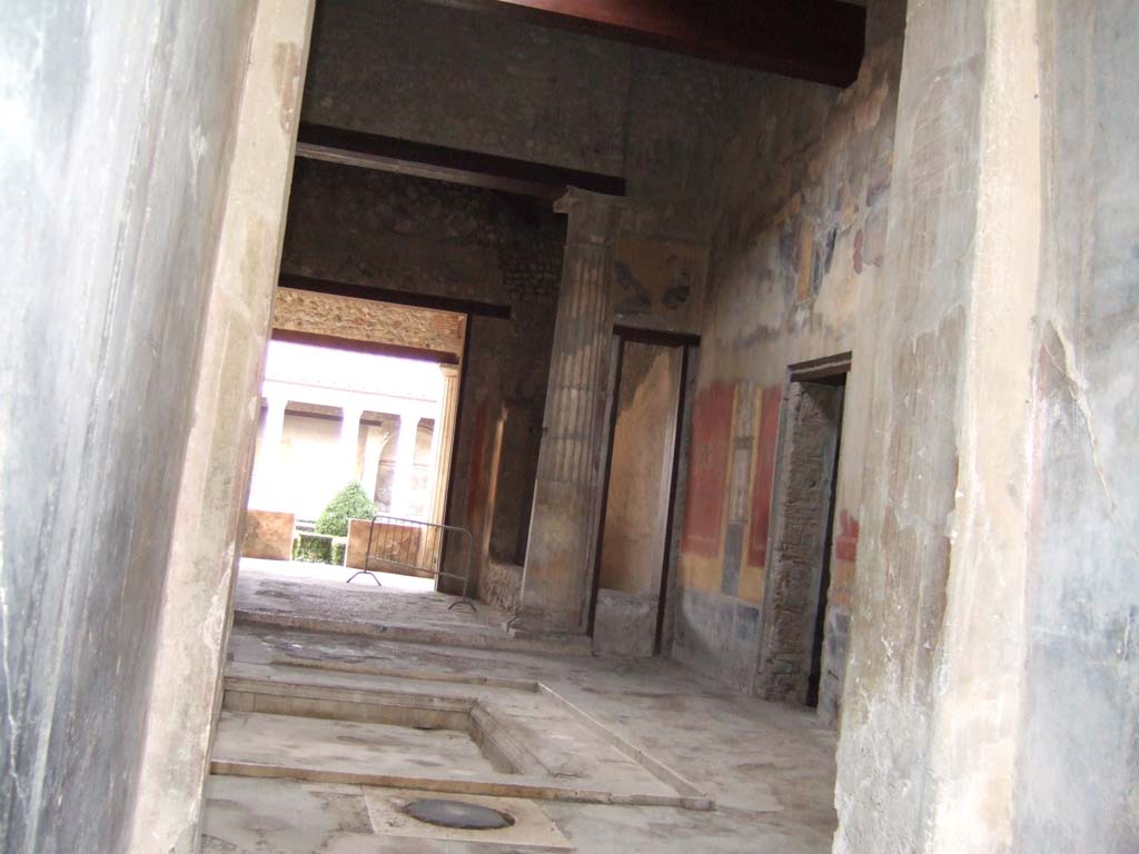 I.10.4 Pompeii. December 2005. Looking towards the south-west corner of the atrium, showing room 8, corridor 10, and room 7.