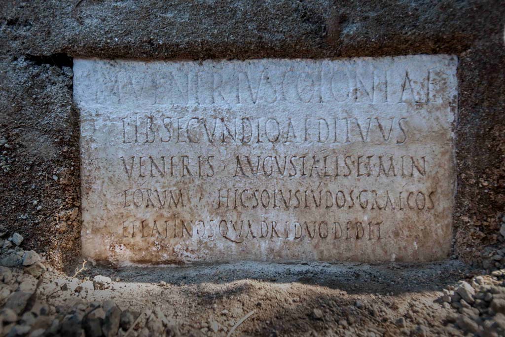Porta Sarno la tomba di Marcus Venerius Secundio. August 2021. 
On a marble slab located on the pediment of the tomb, a commemorative inscription to the owner Marcus Venerius Secundio makes reference, extraordinarily, to performances at Pompeii that were conducted in Greek, direct evidence of which has never before been found.

The figure of Marcus Venerius Secundio - who also appears in the wax tablet archive of the Pompeian banker Caecilius Giocondo, owner of the domus of the same name on Via Vesuvio - was a public slave and custodian of the Temple of Venus. Upon being freed, he reached a certain social and economic status, as can be understood from the rather monumental tomb, and the inscription: in addition to joining the ranks of the Augustales, or the college of priests dedicated to the Imperial Cult, as the epigraph recalls he "gave Greek and Latin ludi for the duration of four days". "Ludi graeci are to be understood as performances in the Greek language': - observes the Director of the Archaeological Park of Pompeii, Gabriel Zuchtriegel.

Sulla lastra marmorea posta sul frontone della tomba un'iscrizione commemorativa del proprietario Marcus Venerius Secundio richiama, straordinariamente, lo svolgimento a Pompei di spettacoli in lingua greca, mai prima attestati in maniera diretta.

Il personaggio di Marcus Venerius Secundio - che compare anche nell'archivio di tavolette cerate del banchiere pompeiano Cecilio Giocondo, proprietario della domus omonima su via Vesuvio – era uno schiavo pubblico e custode del tempio di Venere. Una volta liberato, aveva poi raggiunto un certo status sociale ed economico, come emergerebbe non solo dalla tomba piuttosto monumentale, ma anche dall'iscrizione: oltre a diventare Augustale, ovvero membro del collegio di sacerdoti dediti al culto imperiale, come ricorda l'epigrafe, "diede ludi greci e latini per la durata di quattro giorni". "Ludi graeci è da intendere come spettacoli in lingua greca - commenta il direttore del Parco archeologico di Pompei, Gabriel Zuchtriegel.

M VENERIVS COLONIAE
LIB SECUNDIO AEDITVVS
VENERIS AVGVSTALIS ET MIN
EORVM HIC SOLVS LVDOS GRAECOS
ET LATINOS QVADRIDVO DEDIT

Photograph © Parco Archeologico di Pompei.

According to Virginia Campbell the reads as:

M(arcus) Venerius coloniae
lib(ertus) Secundio, aedituus
Veneris, Augustalis et min(ister)
eorum. Hic solus ludos Graecos
et Latinos quadriduo dedit.

And translates as:

‘Marcus Venerius Secundio, freedmen of the colony, guardian of the temple of Venus, Augustalis and minister of them. He, on his own, gave Greek and Latin games for four days.

See https://pompeiinetworks.wordpress.com/2021/08/19/the-tomb-of-marcus-venerius-secundio/
